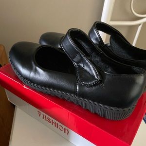 New woman’s black shoes with Velcro strap. Size 9.5.